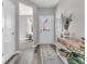 Inviting hallway with modern flooring, console table, and view into the office at 5003 Lilium Dr, Plainfield, IN 46168