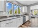 Kitchen boasts stainless appliances, granite counters, and plentiful natural light through large windows at 5003 Lilium Dr, Plainfield, IN 46168