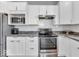 Bright kitchen featuring stainless steel appliances, granite countertops, and white subway tile backsplash at 5003 Lilium Dr, Plainfield, IN 46168