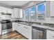 Bright kitchen featuring white cabinetry, stainless steel appliances, and granite counters at 5003 Lilium Dr, Plainfield, IN 46168