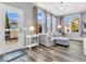 Bright living room featuring a comfortable sofa, large windows, and access to the outdoor patio at 5003 Lilium Dr, Plainfield, IN 46168