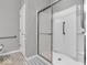Modern shower with glass door, grab bar, and white subway tile surround at 5003 Lilium Dr, Plainfield, IN 46168