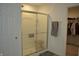 Bathroom shower enclosed with sliding glass door and shower caddy at 5303 Rum Cherry Way, Indianapolis, IN 46237