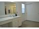 Bathroom featuring vanity with granite countertop and shower with glass door at 5303 Rum Cherry Way, Indianapolis, IN 46237