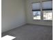 Carpeted bedroom featuring two large windows that provide natural lighting and neutral walls at 5303 Rum Cherry Way, Indianapolis, IN 46237