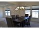 Dining room with contemporary lighting, large windows, and seating for six at 5303 Rum Cherry Way, Indianapolis, IN 46237