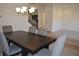 Open concept dining room featuring modern light fixture and seating for six at 5303 Rum Cherry Way, Indianapolis, IN 46237