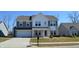 Beautiful two-story home with a two-car garage and a well-manicured front lawn and neutral two-tone paint at 5303 Rum Cherry Way, Indianapolis, IN 46237