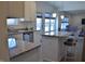 Bright kitchen featuring stainless steel appliances, granite countertops, tiled floor and white cabinets at 5303 Rum Cherry Way, Indianapolis, IN 46237