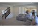 Open-concept living room with staircase and view to the kitchen at 5303 Rum Cherry Way, Indianapolis, IN 46237