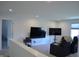 Bright living room with plush carpeting, recessed lighting, and entertainment center with large screen TV at 5303 Rum Cherry Way, Indianapolis, IN 46237