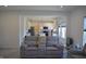 Comfortable living room featuring gray sofas with access to the kitchen and plenty of natural light at 5303 Rum Cherry Way, Indianapolis, IN 46237