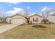 Charming single-story home with a well-manicured lawn and attached two-car garage at 5832 Emmert Way, Indianapolis, IN 46221
