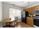 Bright kitchen area with a charming breakfast nook and view of the backyard at 5832 Emmert Way, Indianapolis, IN 46221