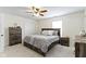 Comfortable main bedroom with ceiling fan, carpet, and traditional wood furnishings at 5832 Emmert Way, Indianapolis, IN 46221
