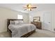Spacious main bedroom with a ceiling fan, carpeted floors, and ample natural light at 5832 Emmert Way, Indianapolis, IN 46221