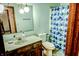 Bathroom featuring a wood vanity and blue patterned shower curtain at 6910 S 175 W, Columbus, IN 47201