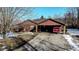 Exterior view of the house featuring an attached carport and a red pickup truck at 6910 S 175 W, Columbus, IN 47201