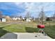 A spacious backyard features mature trees, a small storage shed, and a grill at 7044 Bel Moore Cir, Indianapolis, IN 46259