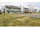 A lush backyard features green lawn, a large patio, and neighboring homes at 7044 Bel Moore Cir, Indianapolis, IN 46259