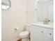 A well-lit powder room with a white vanity, a modern faucet, and a neutral color scheme at 7044 Bel Moore Cir, Indianapolis, IN 46259