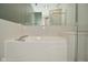 An elegant white bathtub is surrounded by white tiles and a large mirror at 7044 Bel Moore Cir, Indianapolis, IN 46259