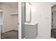 Bathroom features a gray vanity with a white countertop and a framed mirror at 7044 Bel Moore Cir, Indianapolis, IN 46259