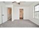Bedroom featuring a ceiling fan, a large window and view to additional rooms in the home at 7044 Bel Moore Cir, Indianapolis, IN 46259
