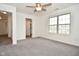 Spacious bedroom with a ceiling fan, a large window and neutral carpeting at 7044 Bel Moore Cir, Indianapolis, IN 46259