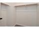 Walk-in closet with custom wooden shelving and neutral colored carpet at 7044 Bel Moore Cir, Indianapolis, IN 46259