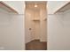 Walk-in closet with custom wooden shelving and neutral colored carpet at 7044 Bel Moore Cir, Indianapolis, IN 46259