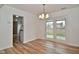 Open dining area with wood-look floors and glass doors providing access to the backyard at 7044 Bel Moore Cir, Indianapolis, IN 46259