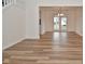 Open dining room with wood-look floors, white walls, and glass doors leading to the backyard at 7044 Bel Moore Cir, Indianapolis, IN 46259