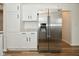 Kitchen featuring stainless steel refrigerator, granite countertops, and modern white cabinets at 7044 Bel Moore Cir, Indianapolis, IN 46259