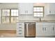 Bright kitchen featuring stainless steel dishwasher, granite countertops, and ample cabinet space at 7044 Bel Moore Cir, Indianapolis, IN 46259