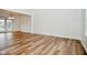 Spacious living room featuring wood-look flooring, ample natural light, and fresh white walls at 7044 Bel Moore Cir, Indianapolis, IN 46259