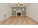 Spacious living room with hardwood floors, a fireplace, and accent wall at 7044 Bel Moore Cir, Indianapolis, IN 46259