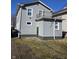 Exterior view of the home featuring a small upper deck and well-maintained siding at 721 N Grant Ave, Indianapolis, IN 46201