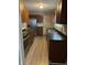 Modern kitchen with stainless steel appliances, dark countertops, and sleek wooden cabinetry at 721 N Grant Ave, Indianapolis, IN 46201