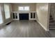 Bright living room featuring hardwood floors, a fireplace, and built-in shelving at 721 N Grant Ave, Indianapolis, IN 46201