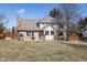 View of backyard featuring well-maintained lawn, wooden deck and mature trees with home at 7411 Perrier Dr, Indianapolis, IN 46278