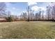 Expansive backyard showcasing a well-maintained lawn and a sturdy wooden fence, offering privacy at 7411 Perrier Dr, Indianapolis, IN 46278