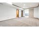 A carpeted basement is adjacent to a bathroom and storage room, offering ample space for various activities at 7411 Perrier Dr, Indianapolis, IN 46278