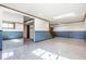 Finished basement area featuring a large living space, mirrored door, and a staircase at 7411 Perrier Dr, Indianapolis, IN 46278