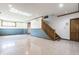 Finished basement area featuring a large living space, full bath, and a staircase at 7411 Perrier Dr, Indianapolis, IN 46278