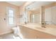 Bright bathroom featuring a double vanity, tiled shower, and a large window at 7411 Perrier Dr, Indianapolis, IN 46278