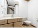 Neutral half bathroom featuring a vanity with a sink and a toilet, perfect for guests at 7411 Perrier Dr, Indianapolis, IN 46278