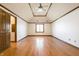 Expansive bedroom with wood floors, vaulted ceilings, ceiling fan, and a large window for natural light at 7411 Perrier Dr, Indianapolis, IN 46278