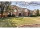 Beautiful home with brick exterior, lush lawn, mature trees, and welcoming walkway at 7411 Perrier Dr, Indianapolis, IN 46278
