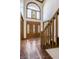 Elegant foyer showcasing a wooden front door, stained glass, tile floor, and staircase at 7411 Perrier Dr, Indianapolis, IN 46278